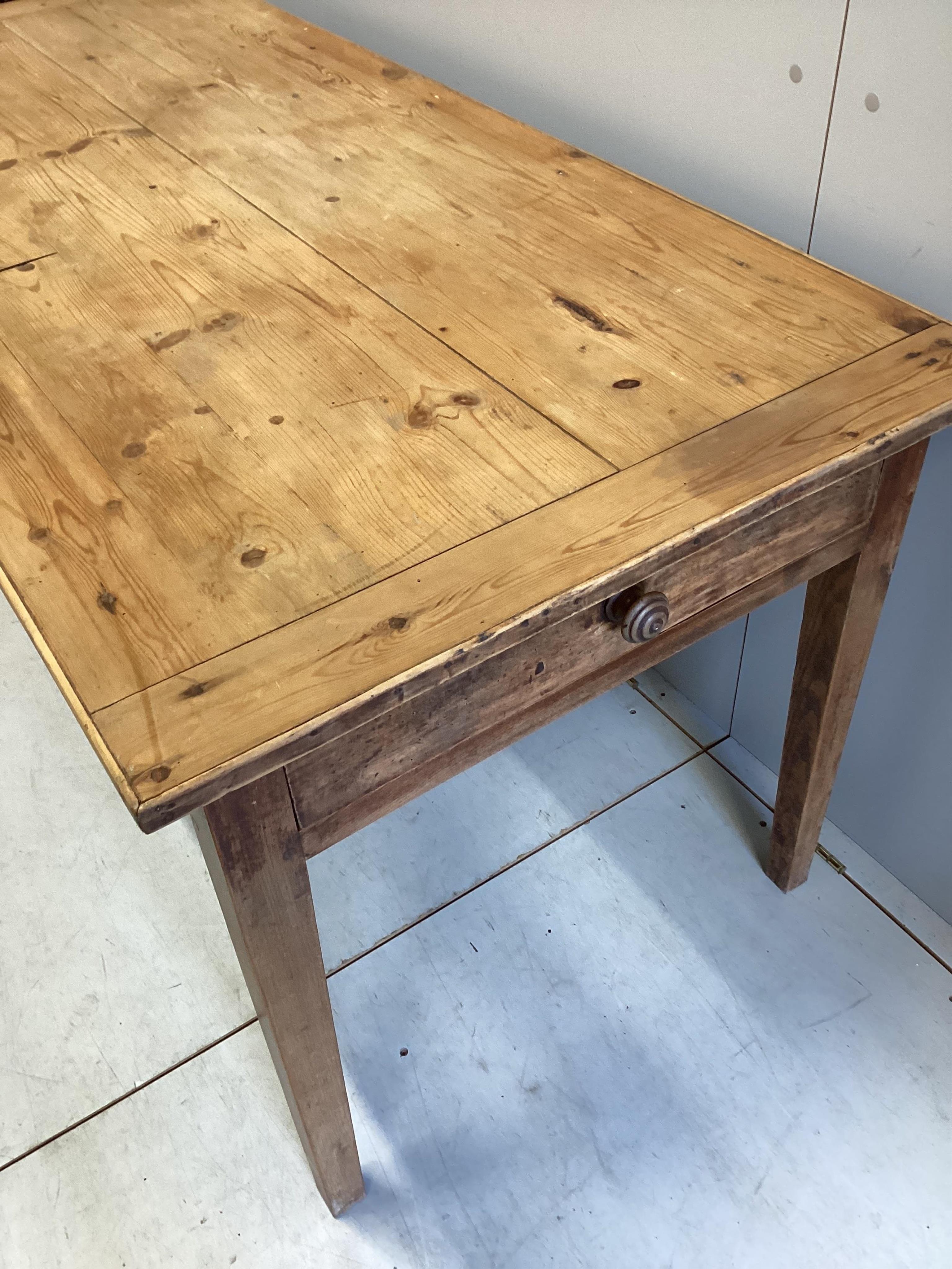 A 19h century French rectangular pine and fruitwood two drawer kitchen table, width 172cm, depth 78cm, height 76cm. Condition - fair, top with slightly opened joints and has traces of old worm.